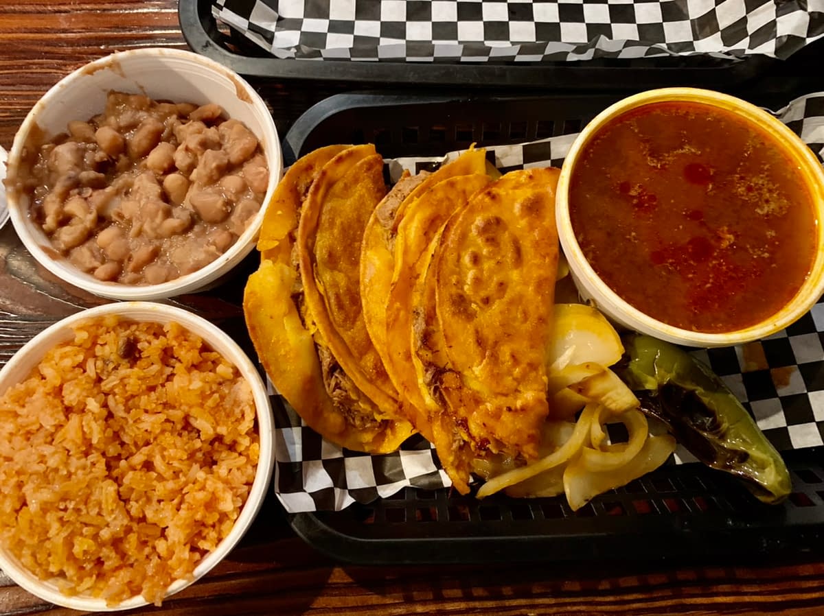 A Plate of three birria tacos with consome and rice & beans at Los Tapatios in Salt Lake City