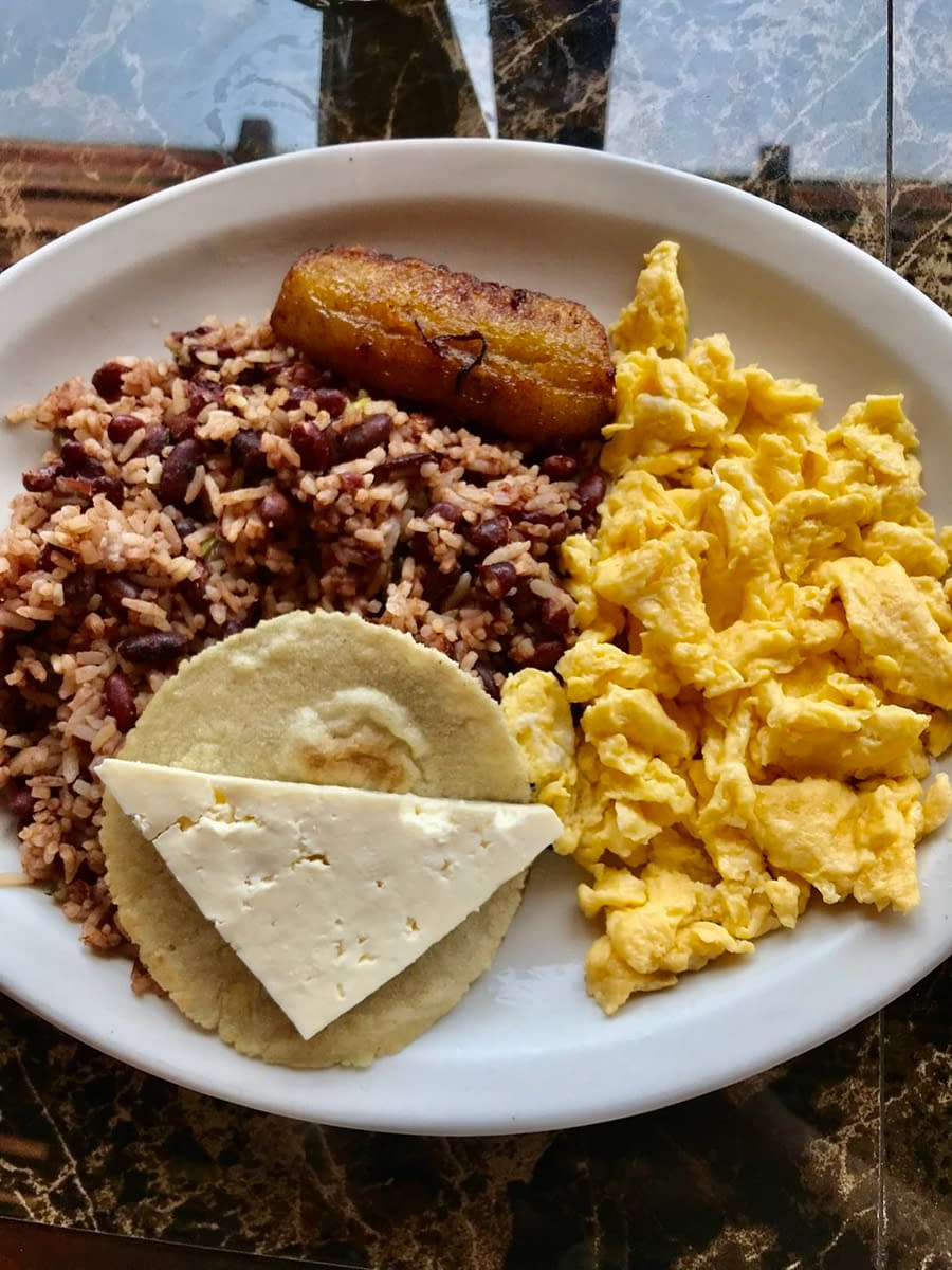 A typical Costa Rican breakfast featuring gallo pinto and eggs