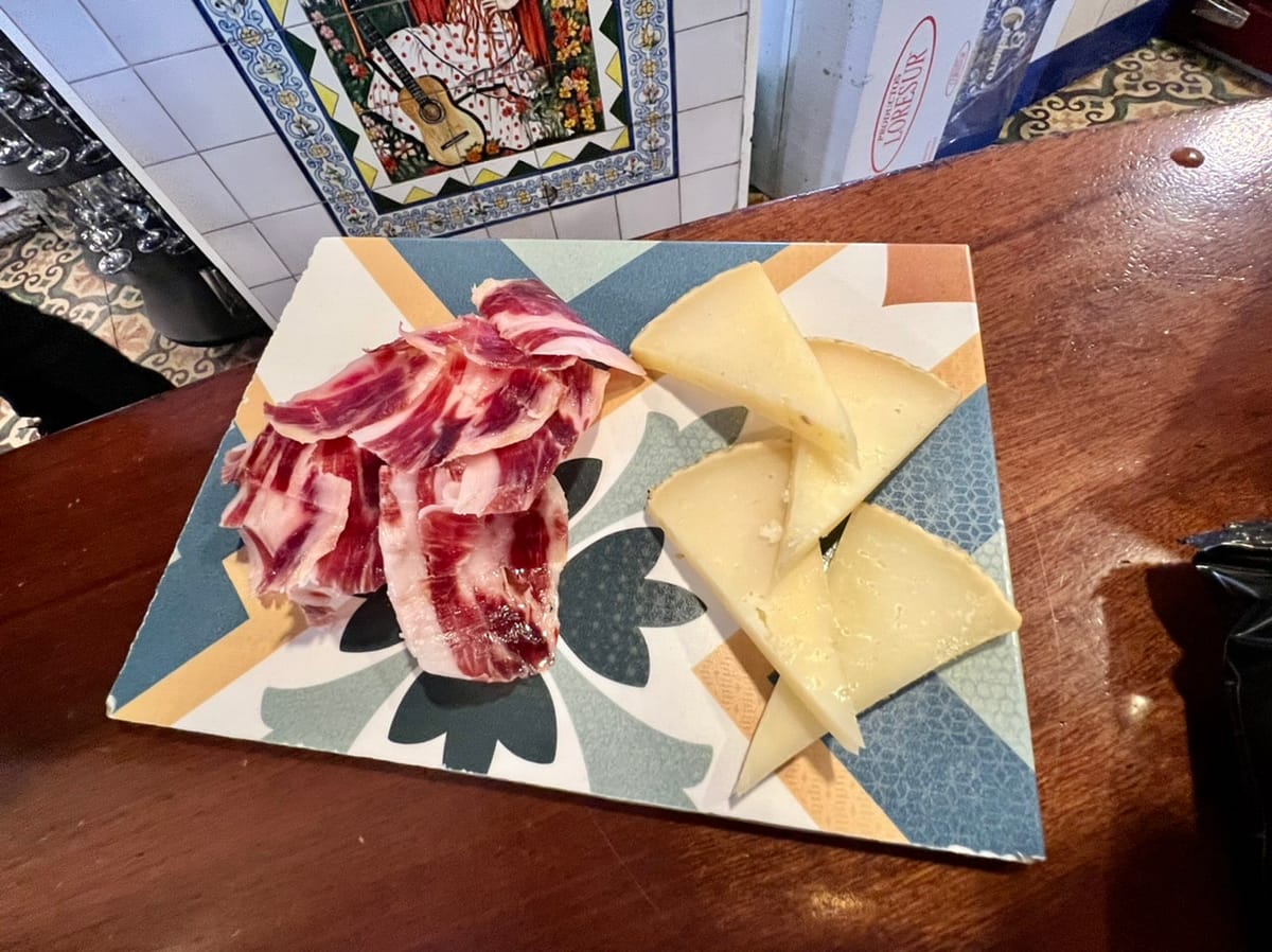 A plate with two tapas in Seville Spain - Iberian Ham and Payoyo Cheese