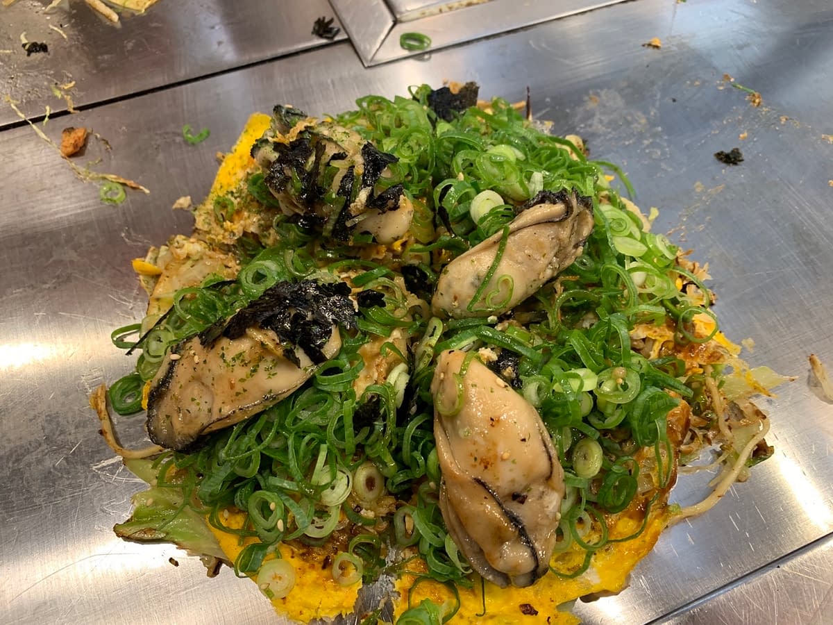 Okonomiyaki - Japanese cabbage pancakes.  This one topped with large Hiroshima oysters