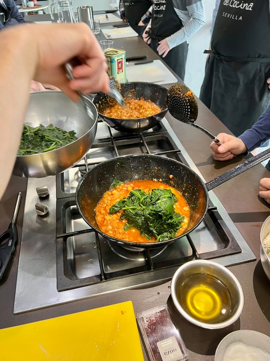 Preparing Spinach and Chickpeas during a cooking class in Seville Spain