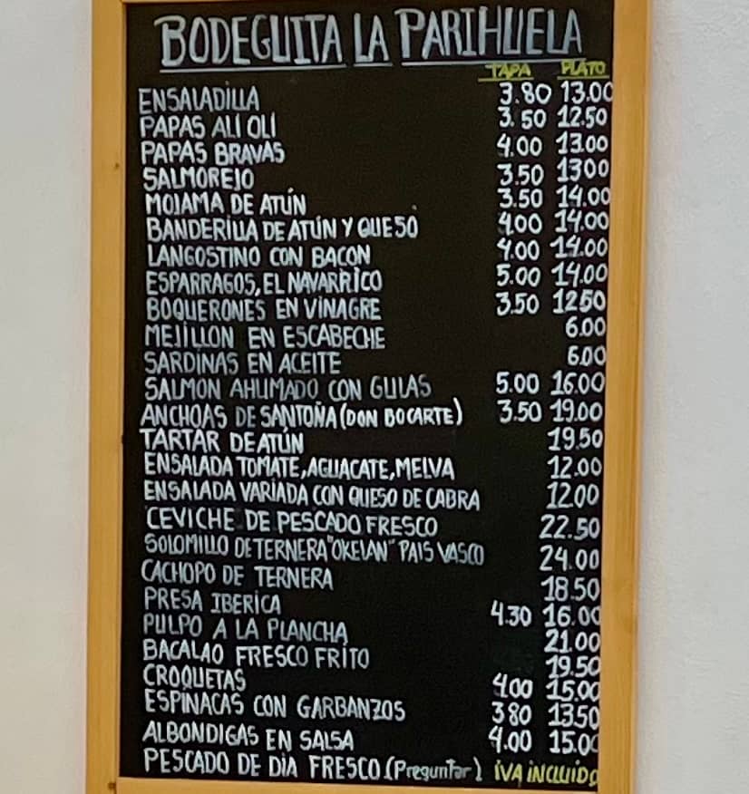 A tapas bar menu posted on a chalkboard outside