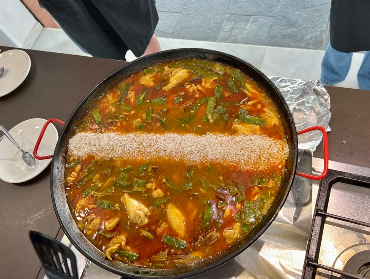 Rice spread across a paella pan