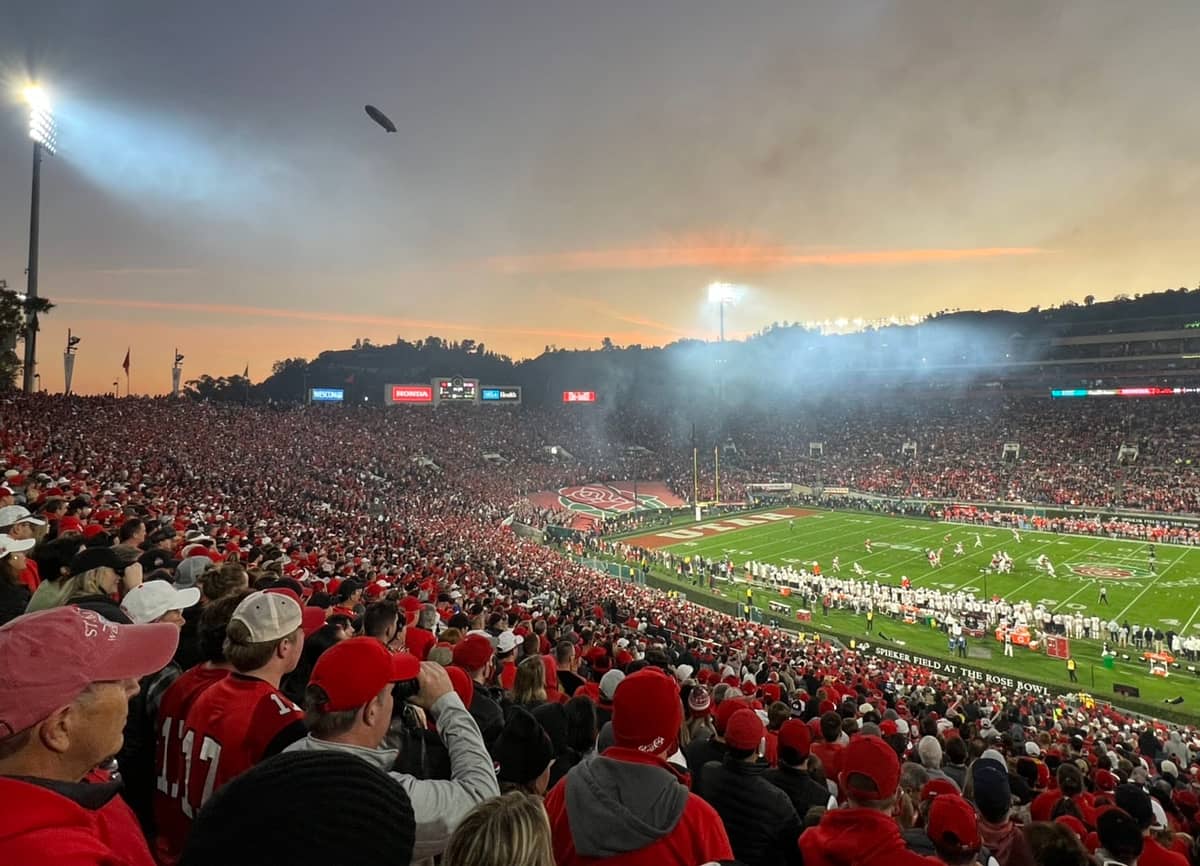 Smoke, sunset, and a blimp at Rose Bowl Stadium