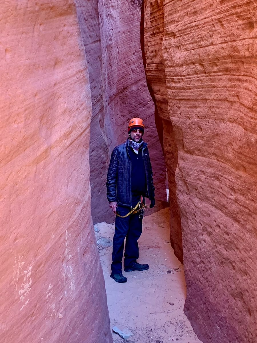 The Thorough Tripper standing in a Utah Slot Canyon while canyoneering
