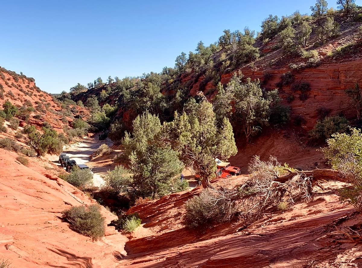 UTVs and SUVs parked near the entrance to Peek-A-Boo Slot Canyon near Kanab Utah