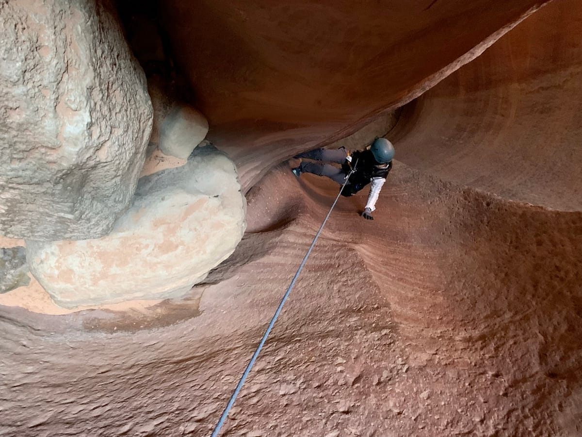 Halfway down the longest rappel in Ladder Slot Canyon