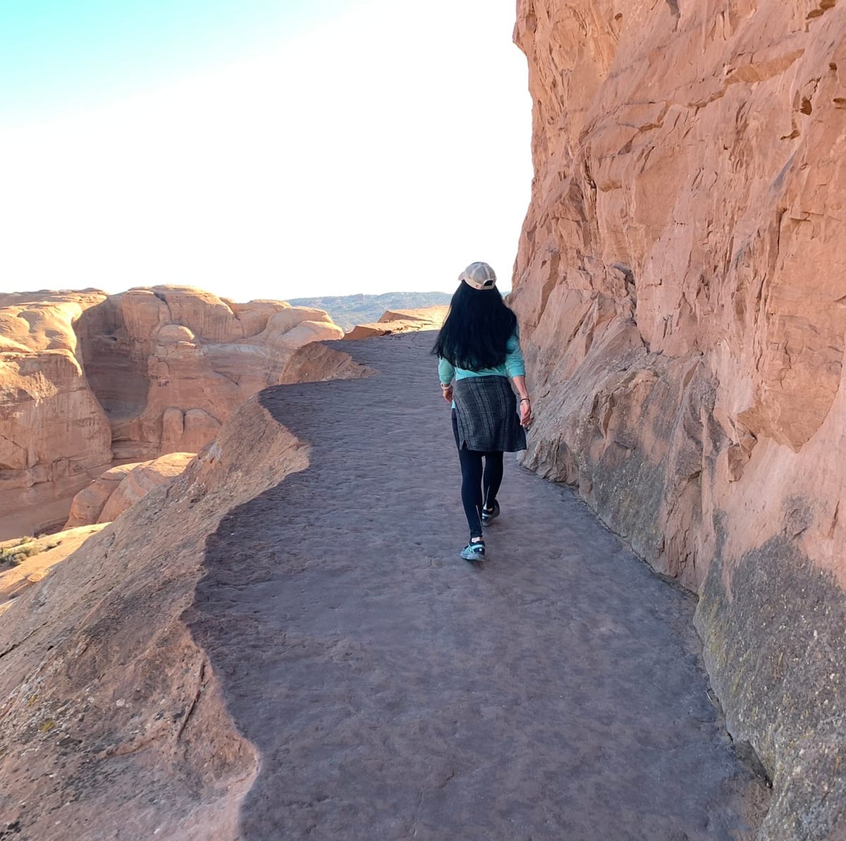 Walking along the ledge near the end of the Delicate Arch hike.  The arch is just around the corner up ahead