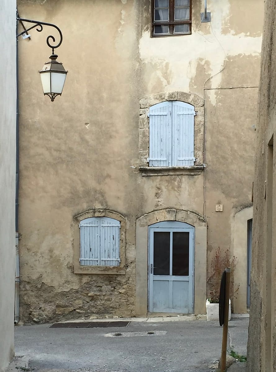 Blue doors and windows in a back alley in Lourmarin France
