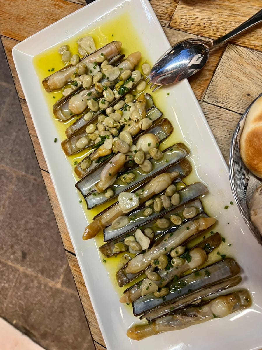A racion of razor clams with broad beans in Seville Spain