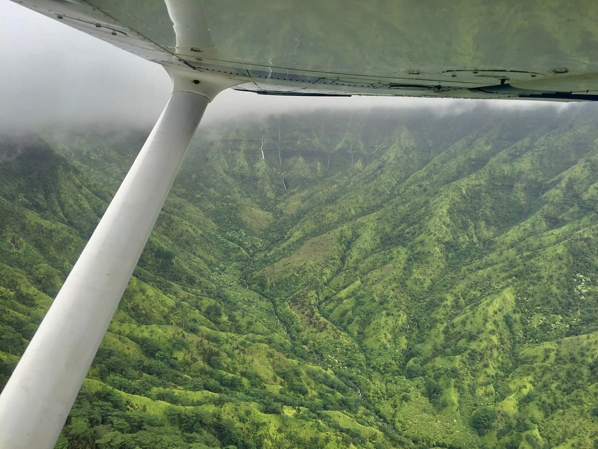 Waterfalls just under the wing as we fly across the center of Kauai