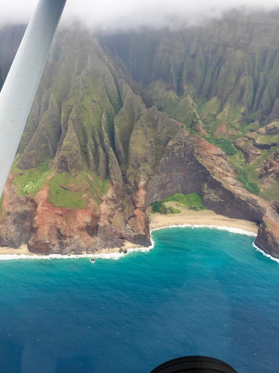 Looking down on the Napali Coast from inside a Cessna