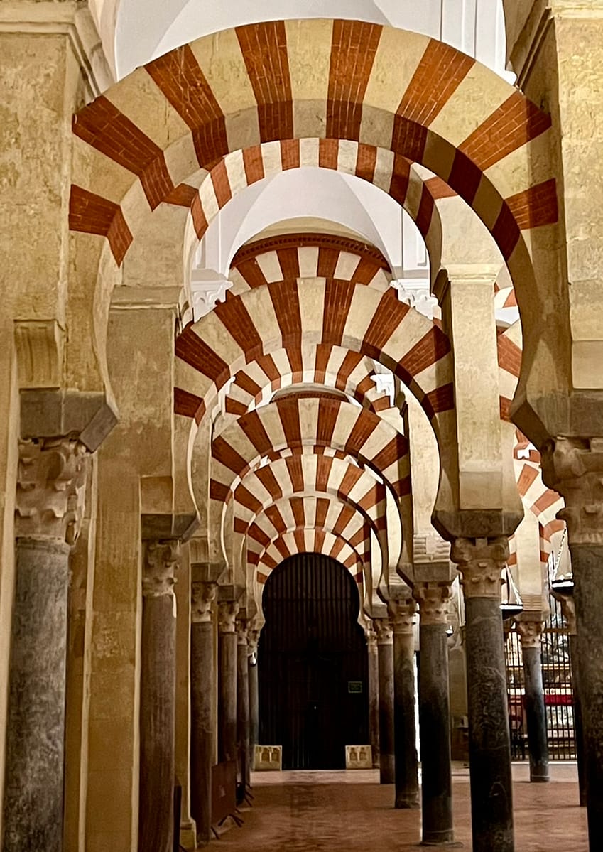 Red and white arches lined up in Cordoba's Mesquita - an absolute necessary day trip from Seville