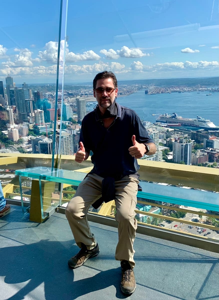 Sitting on the edge of the outdoor observation deck while visiting the Space Needle