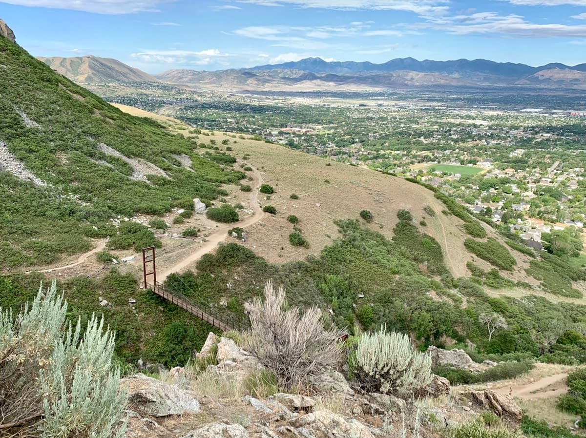 Looking down from the Bear Canyon Loop Trail to the Bear Canyon Suspension Bridge and out across Draper Utah