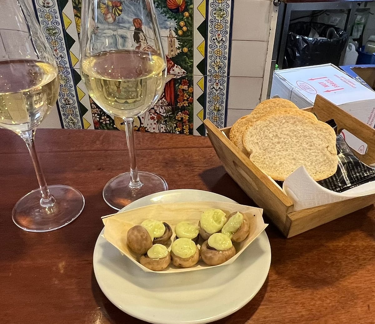 A tapas of mushrooms and aioli served with glasses of manzanilla sherry in Seville Spain