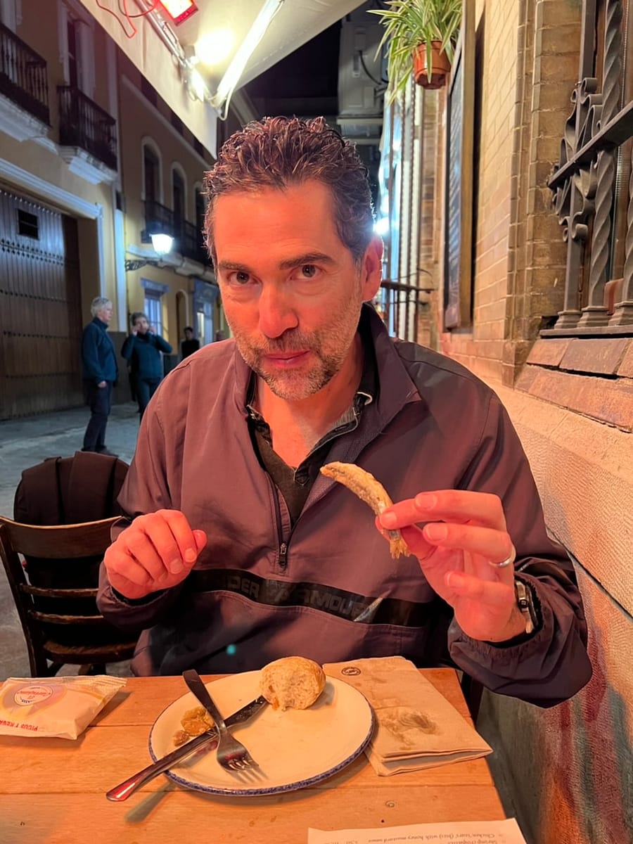 Finishing off a tapas of fried anchovies in Seville Spain