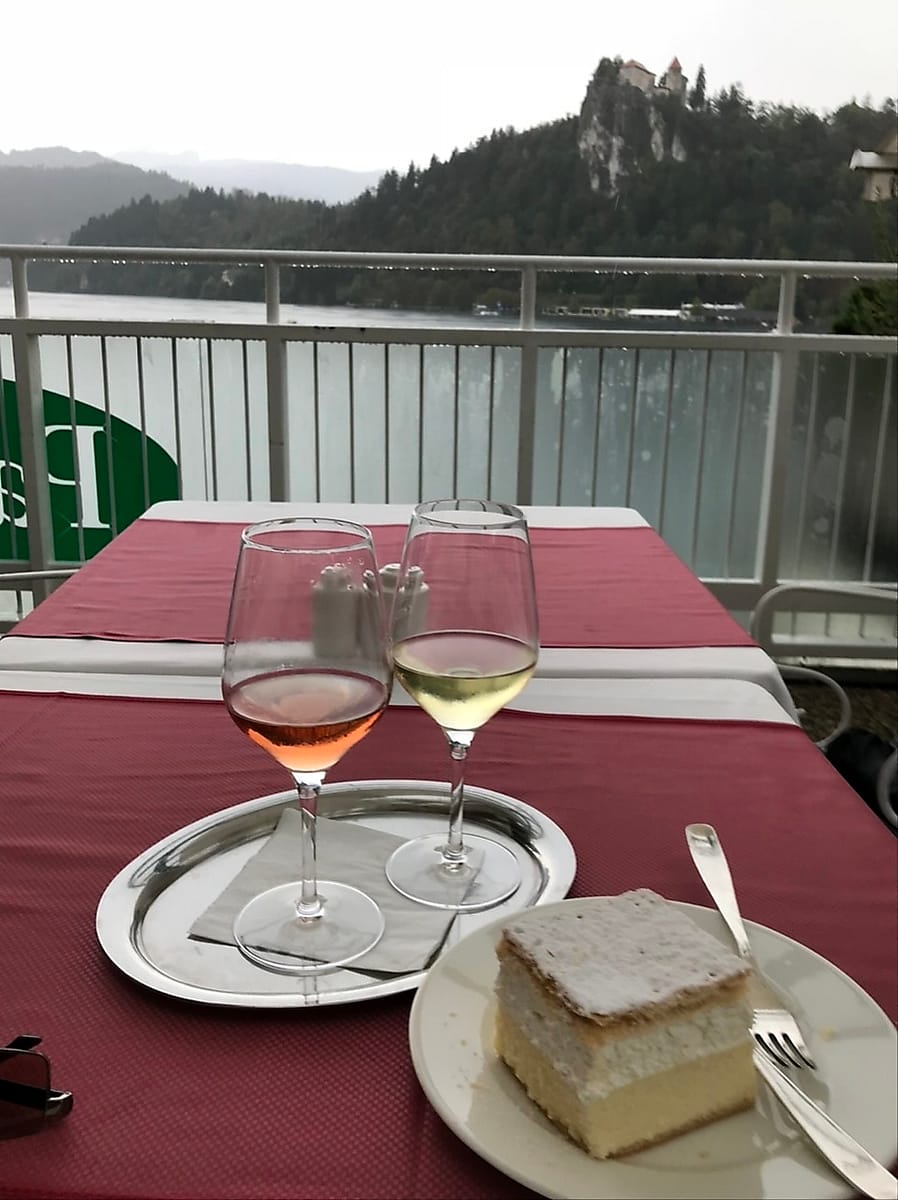 Wine and Bled Cake alongside Lake Bled