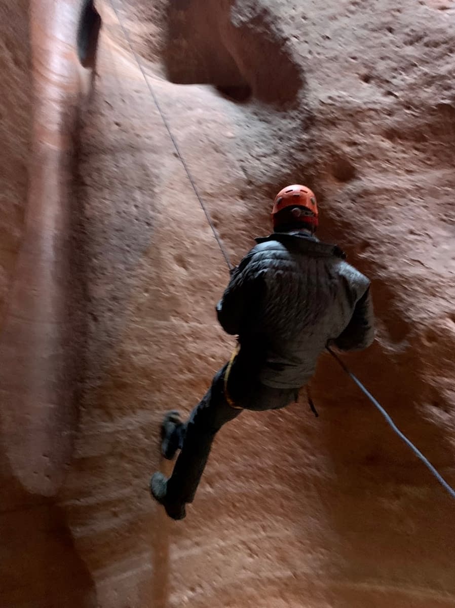 Near the end of a 65 foot rappel in an Orderville Utah slot canyon