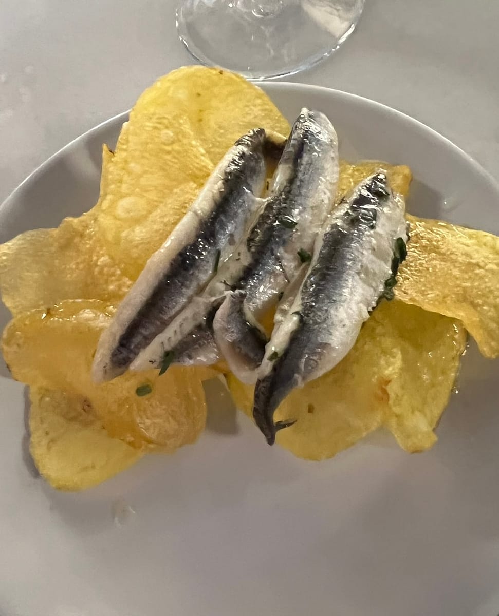 A free tapa of pickled anchovies and potato chips in Granada Spain