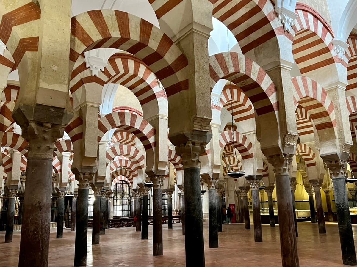 The red and white arches in the prayer hall in Cordoba's Mesquita - an essential day trip from Seville